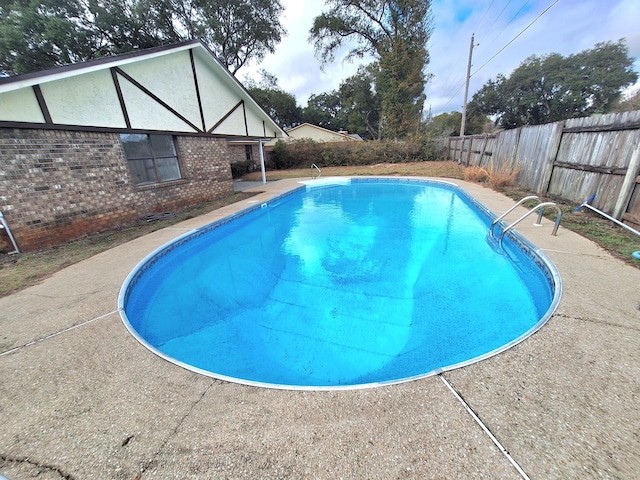 view of pool with a fenced in pool, a fenced backyard, and a patio