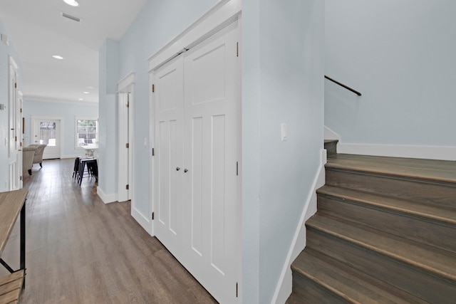 staircase with hardwood / wood-style floors