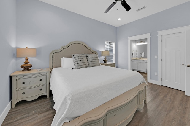 bedroom with ceiling fan, connected bathroom, and dark hardwood / wood-style floors