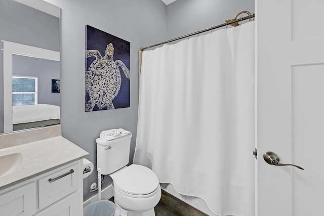 bathroom with hardwood / wood-style flooring, vanity, and toilet