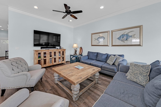 living room with dark wood-type flooring, ornamental molding, and ceiling fan