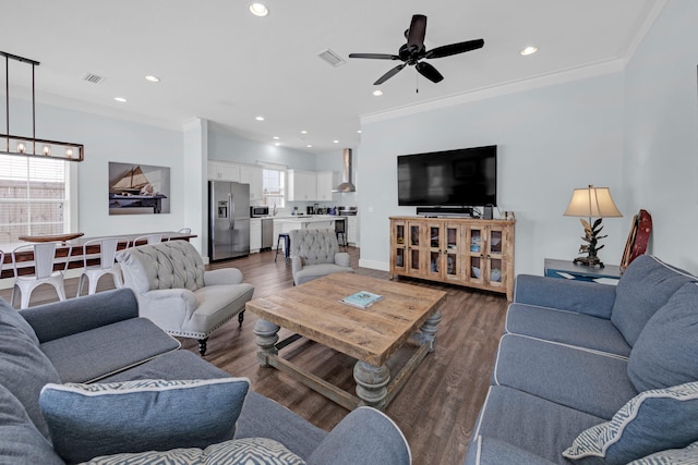 living room featuring ornamental molding, dark wood-type flooring, and ceiling fan