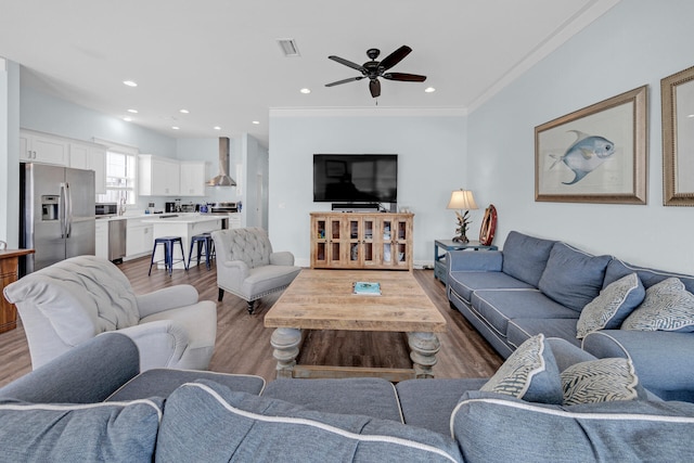 living room featuring dark hardwood / wood-style flooring, crown molding, and ceiling fan