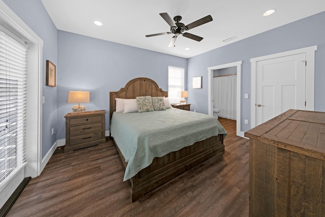 bedroom featuring dark wood-type flooring, ceiling fan, and connected bathroom