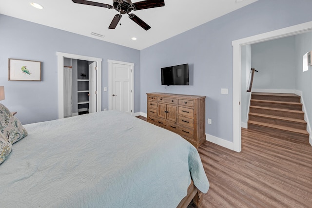 bedroom with hardwood / wood-style floors and ceiling fan