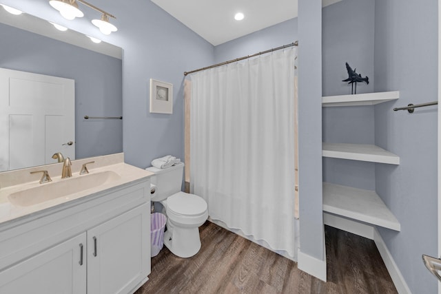 bathroom featuring a shower with curtain, vanity, hardwood / wood-style floors, and toilet