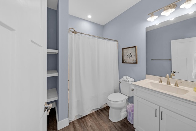 bathroom with vanity, hardwood / wood-style floors, curtained shower, and toilet