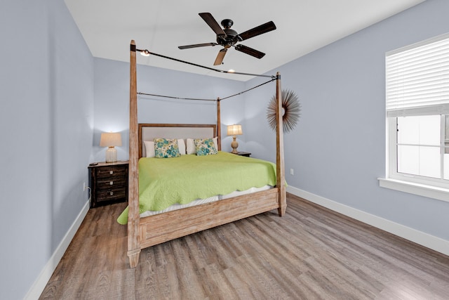 bedroom with hardwood / wood-style flooring and ceiling fan