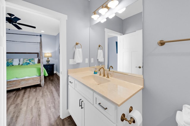 bathroom featuring hardwood / wood-style flooring, ceiling fan, and vanity