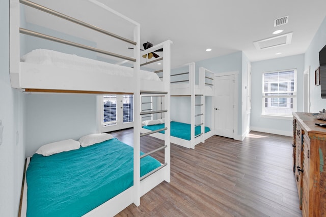 bedroom with french doors and hardwood / wood-style floors