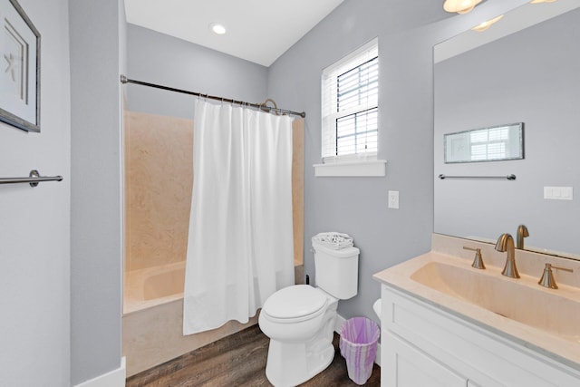 full bathroom featuring vanity, toilet, shower / tub combo, and hardwood / wood-style floors