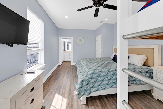 bedroom with wood-type flooring, connected bathroom, and ceiling fan