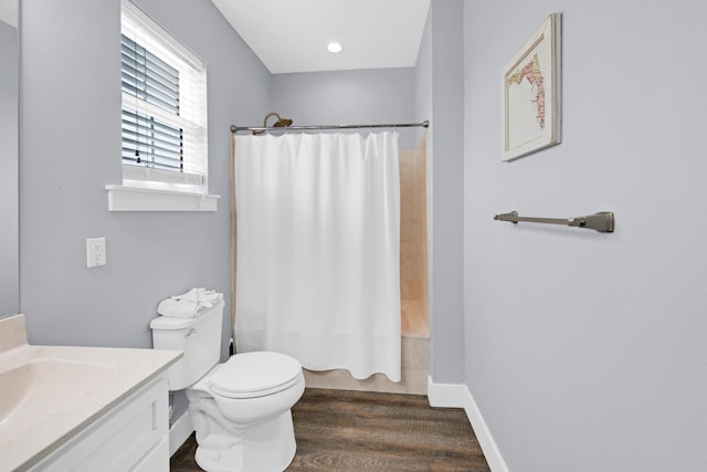 full bathroom with vanity, hardwood / wood-style floors, shower / bath combination with curtain, and toilet