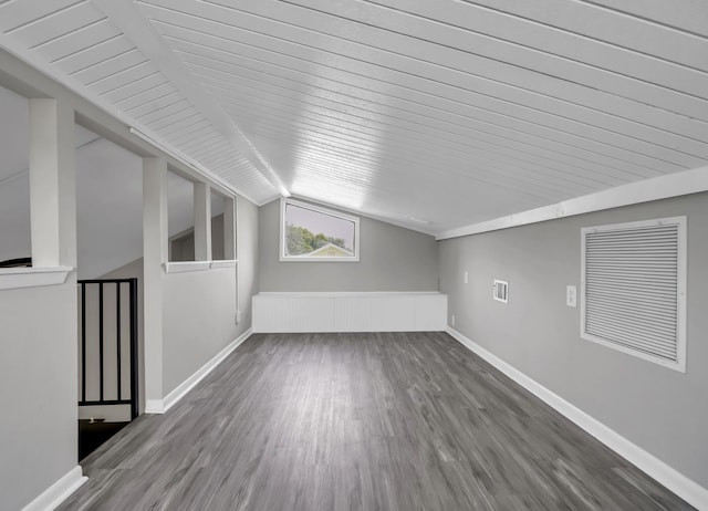 bonus room with lofted ceiling and hardwood / wood-style floors