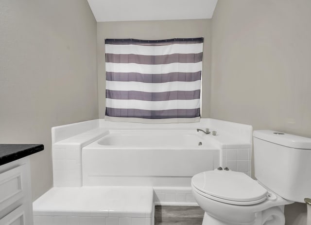 bathroom with vanity, a bathtub, and toilet