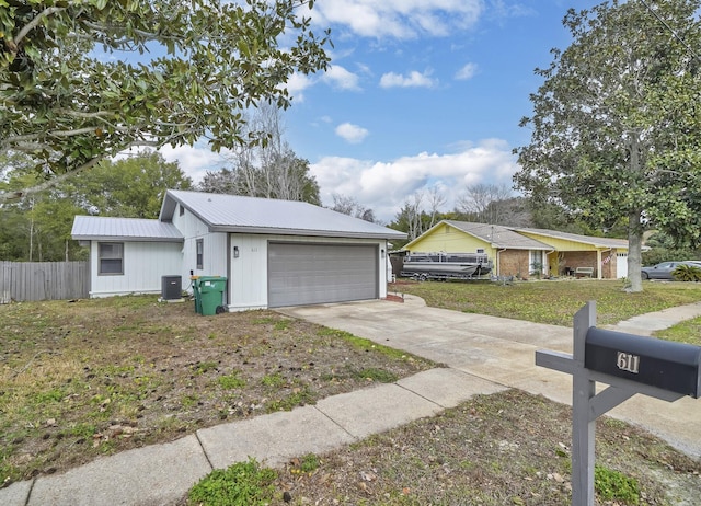 single story home featuring a garage, a front yard, and central air condition unit