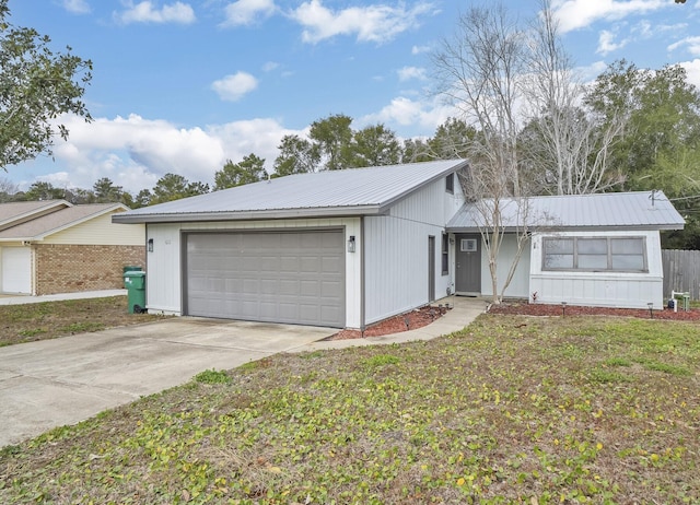 single story home featuring a garage and a front yard