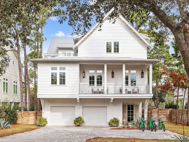 view of front of home with a garage and a balcony