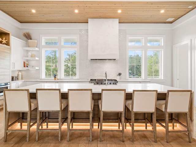 kitchen with wood ceiling, a kitchen breakfast bar, and a center island