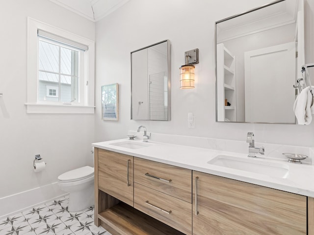 bathroom featuring vanity, ornamental molding, and toilet