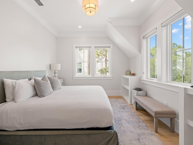 bedroom featuring crown molding and light hardwood / wood-style flooring