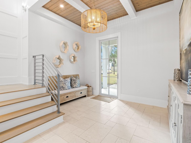 doorway to outside featuring a notable chandelier, beam ceiling, and wooden ceiling