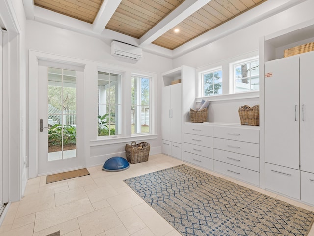 mudroom featuring beamed ceiling, plenty of natural light, wood ceiling, and a wall unit AC