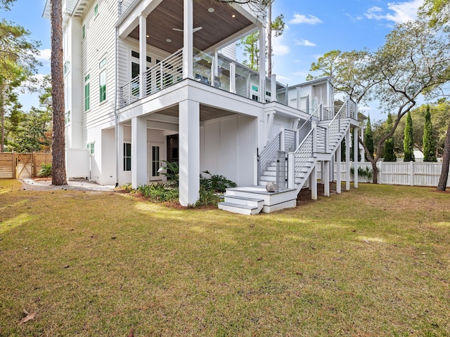 rear view of property featuring a yard