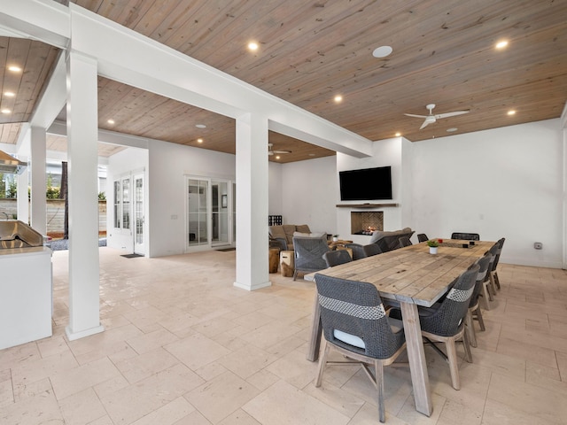 dining space featuring ceiling fan and wood ceiling