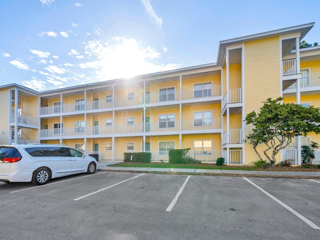 view of building exterior featuring uncovered parking