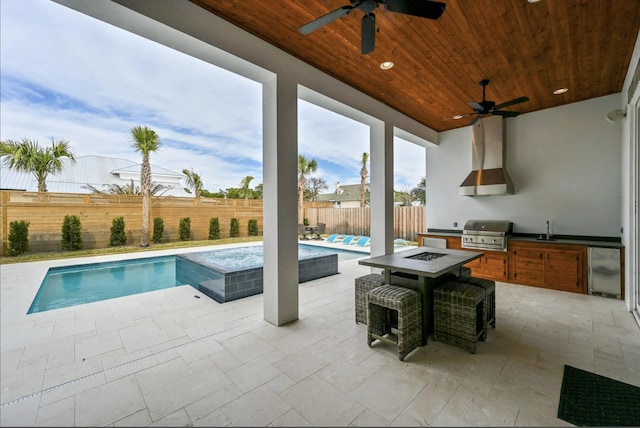 view of swimming pool featuring a patio, area for grilling, sink, and a fire pit