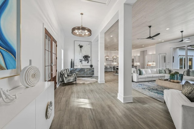 entrance foyer featuring ceiling fan with notable chandelier and hardwood / wood-style floors