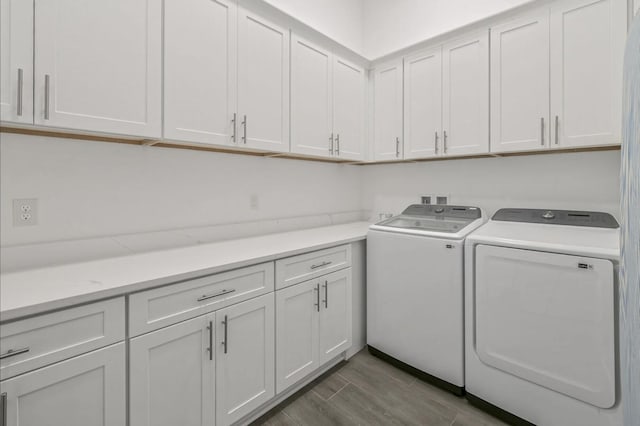 laundry area featuring cabinets and washer and clothes dryer