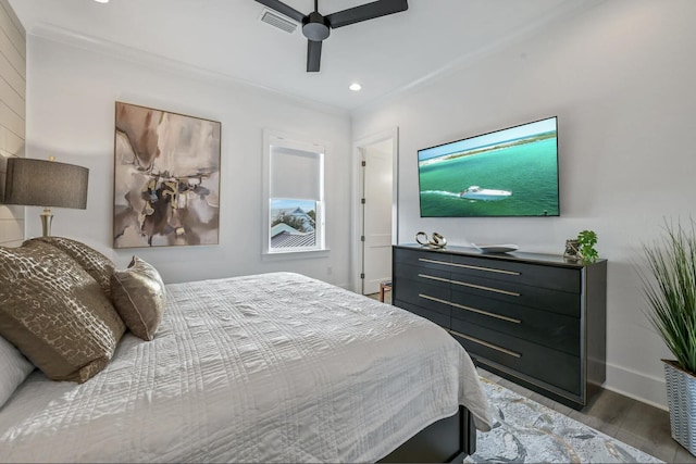 bedroom featuring crown molding, hardwood / wood-style flooring, and ceiling fan