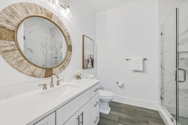 bathroom featuring vanity, toilet, and a shower with shower door