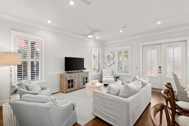 living room with hardwood / wood-style flooring and crown molding