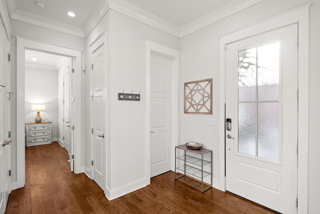 foyer entrance with ornamental molding and dark wood-type flooring