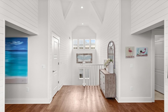 corridor featuring lofted ceiling and hardwood / wood-style floors