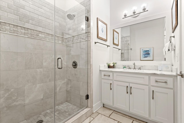 bathroom with vanity and a shower with door