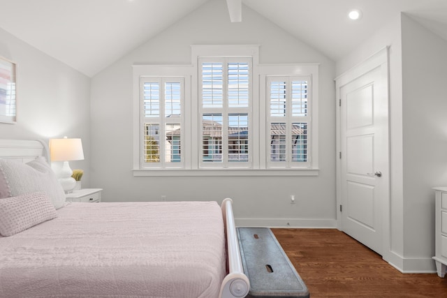 bedroom with lofted ceiling and dark hardwood / wood-style floors