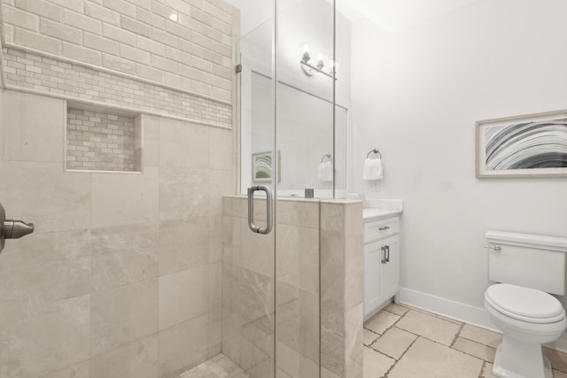 bathroom with vanity, toilet, and a shower with door