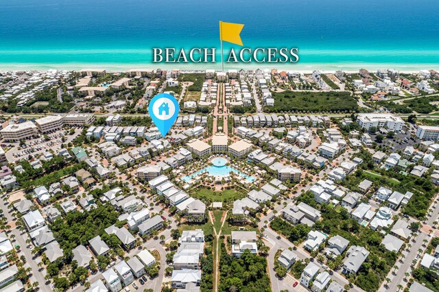 birds eye view of property featuring a water view and a view of the beach