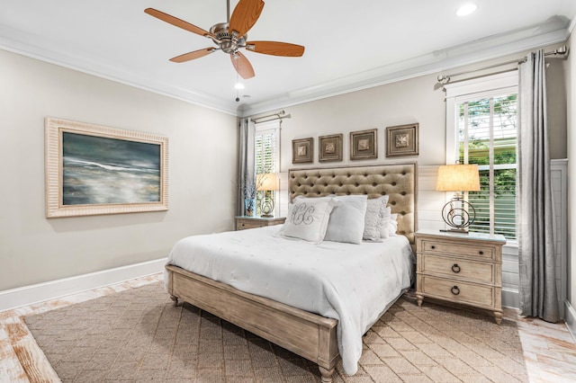 bedroom with ceiling fan, ornamental molding, and multiple windows