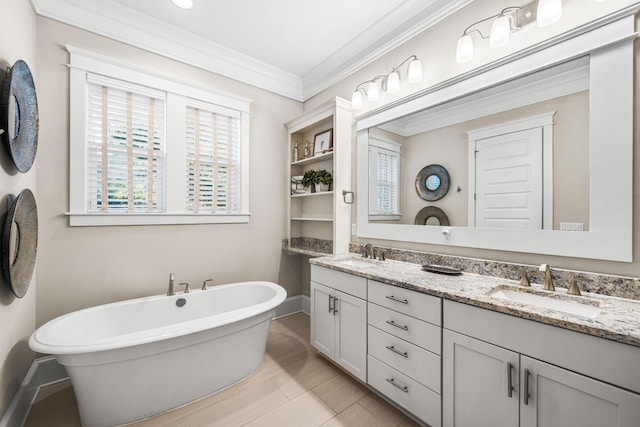 bathroom featuring a bathing tub, ornamental molding, and vanity