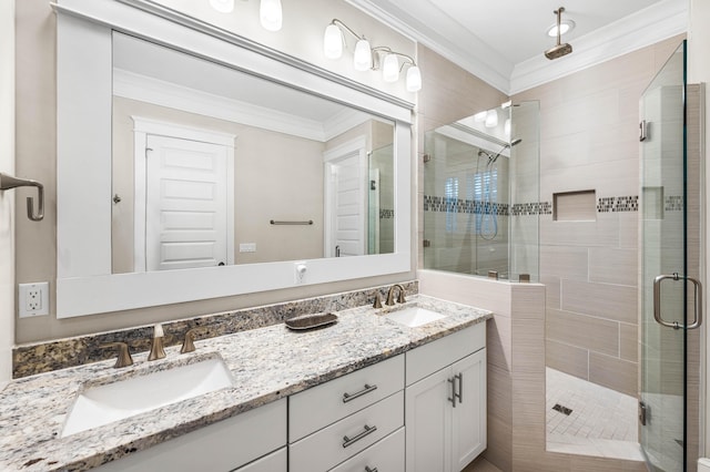 bathroom with crown molding, vanity, and walk in shower