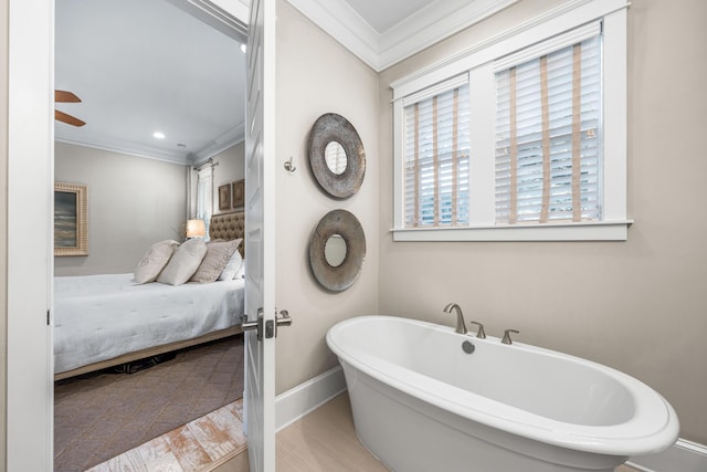 bathroom featuring a bathing tub, ceiling fan, and crown molding