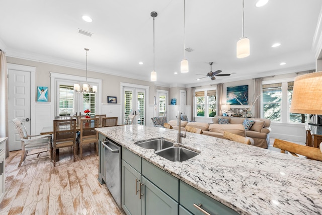 kitchen featuring hanging light fixtures, ornamental molding, and sink