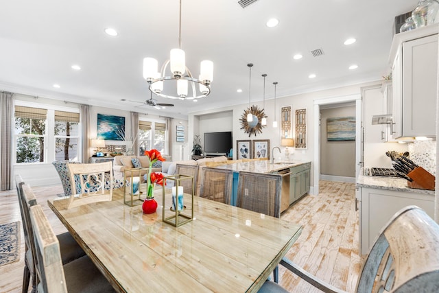 dining room with crown molding, ceiling fan, plenty of natural light, and sink