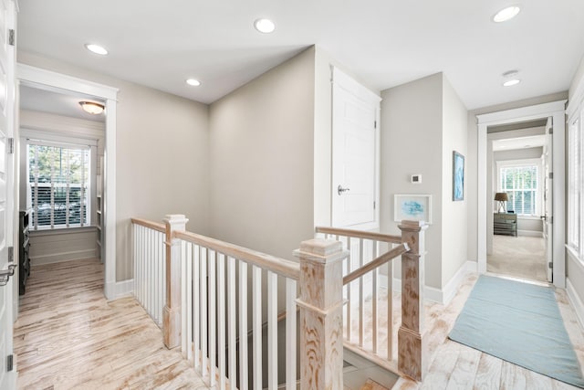 hallway with light hardwood / wood-style floors