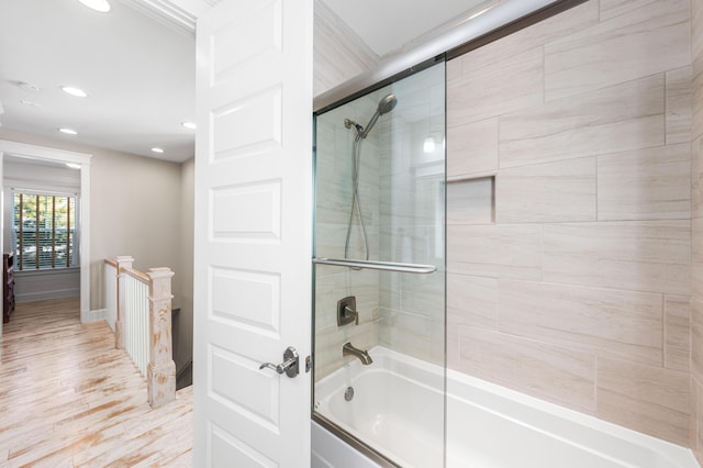 bathroom featuring enclosed tub / shower combo and hardwood / wood-style floors